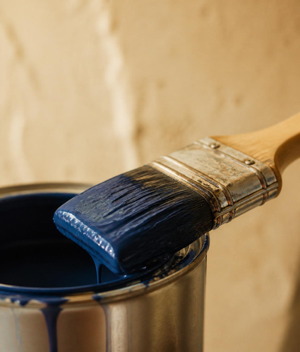 Paintbrush loaded with deep blue paint